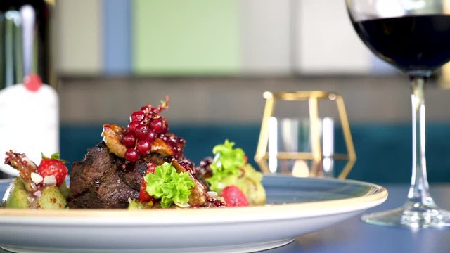 Grilled steack beef meat on a plate with sweet berries