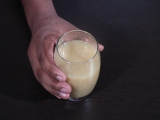 Fenugreek Seeds or Methi Dana drink by soaking it in water overnight. helpful in weight loss, digestion and blood sugar treatment, Methi Dana Drink in Glass on Wooden Background