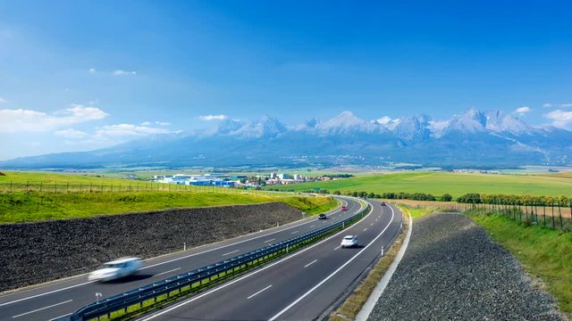 Time lapse footage of  highway leading to rocky peaks of High Tatras mountains, Slovakia during a summer day.