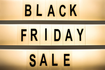 Black friday sale concept. Fourth Friday of November, beginning of Christmas shopping season since 1952. Glowing lightbox with promo text. Background, copy space, close up, top view, flat lay