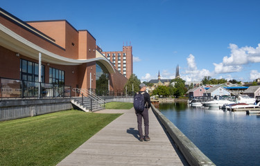 Man's Back View Walking on the Boardwalk in the Waterfront of Charlottetown Prince Edward Island...