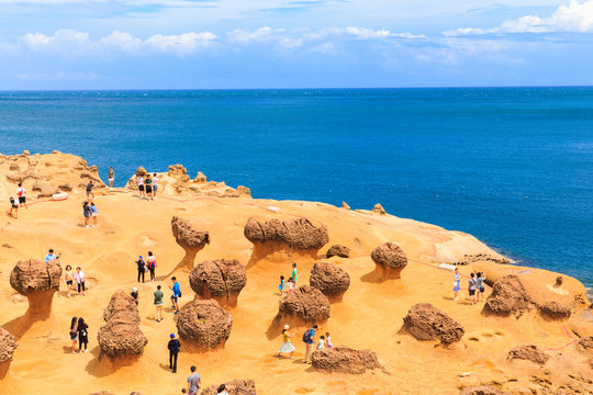 YEHLIU,TAIWAN-AUGUST 22,2017: Many tourists watch the stone Strange shape at Yehliu Geopark,These rock caused by the erosion of sea waves