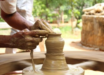 A potter making a pottery earthenware in progress clay