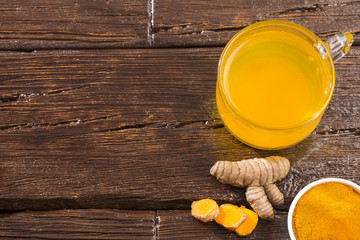 Infused turmeric drink healthy - Wooden background