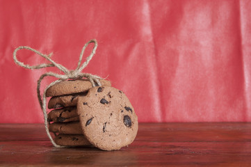 freshly baked chocolate chip cookies on rustic wooden table