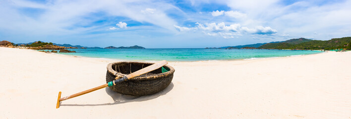Vietnamese round boat. White sand beach. Vietnam. Panorama