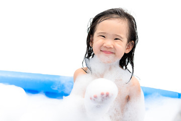 Happy little girl playing in bath tube with foam bubbles. Little child in a bathtub, smiling kid in bathroom, Hygiene and care for young children.