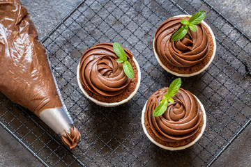 chocolate cupcake with chocolate cream in white capsules