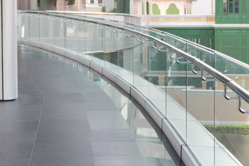 tempered glass of walk way balcony with stainless steel handrail.