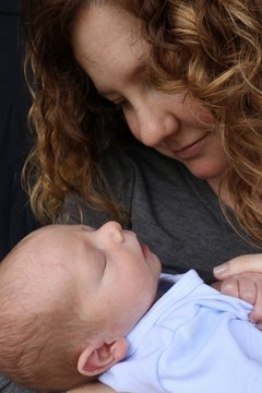 Young mother lovingly looking at her newborn