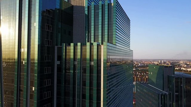 Astana skyscrapers shot on flying camera copter. Aerial sunset view of city.