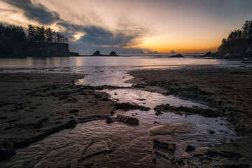 Sunset Beach State Park sunset with stream, beach and colorful sky.