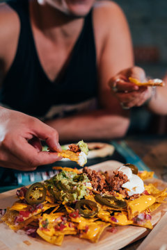 Couple Eating Street Tacos And Nachos At Outdoor Mexican Restaurant. Mexican Food.