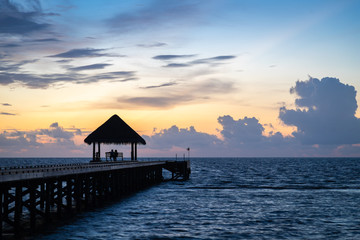 Wodden hut at the end of a jettty at sunset