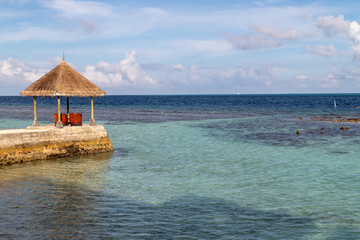 Hut on a concrete dock on tropical island