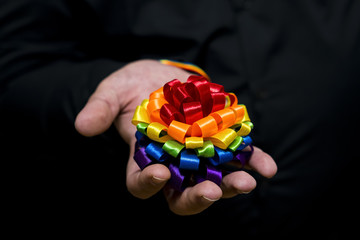 LGBT community. Symbolic rainbow flag on the box in hand.