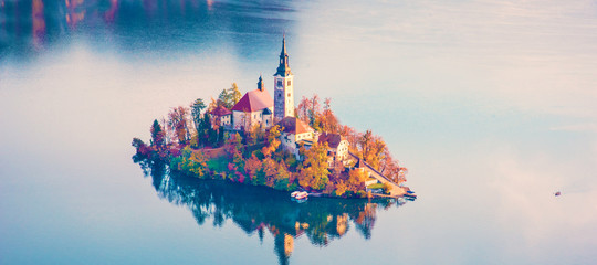 Magical autumn landscape with the island on Lake Bled (Blejsko jezero). Julian Alps, Slovenia....