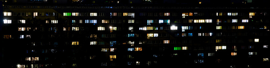windows of apartment buildings at night, the light from the windows of houses, the evening...