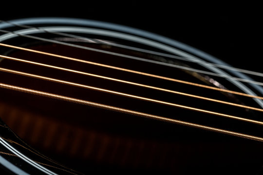 Bronze strings of black guitar. Music background