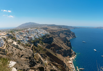 Panoramic view on Thira town and rocky coastline of Santorini island, Greece
