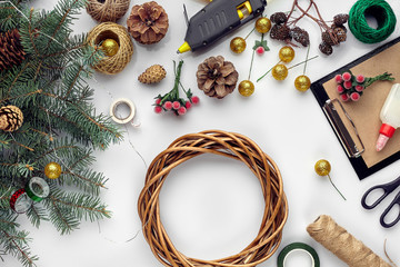 Preparing for Christmas or New Year holiday. Flat-lay of fur tree branches, wreaths, rope,...