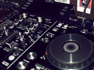 Sound mixing console detail, close up. DJ professional music console of black sound mixer...
