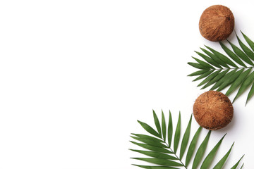 coconuts and tropical leaves top view on a white background