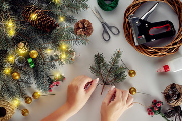 Christmas background with decorations, garland and pine cones. Creating wreath made of christmas...