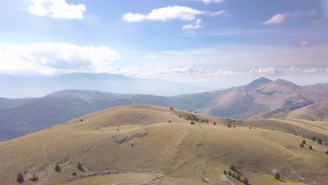 AERIAL: drone flying over the mountains near to the Gran Sasso mountain, Abruzzo, Italy, in a sunny day.