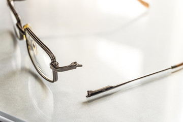 Eyeglasses with a broken shackle. Selective focus.