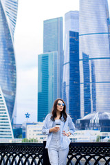 beautiful girl in the city drinks coffee