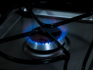 Close-up blue flame burning gas of a gas cooking stove - gas burners - stove mouth