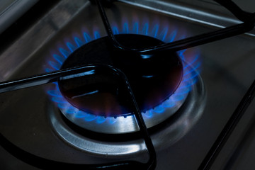 Close-up blue flame burning gas of a gas cooking stove - gas burners - stove mouth