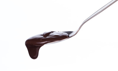 chocolate dripping from a spoon isolated on white background