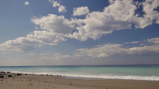 Beautiful waves on sandy beach on Sicili, Italy. Sunny day on the beach.