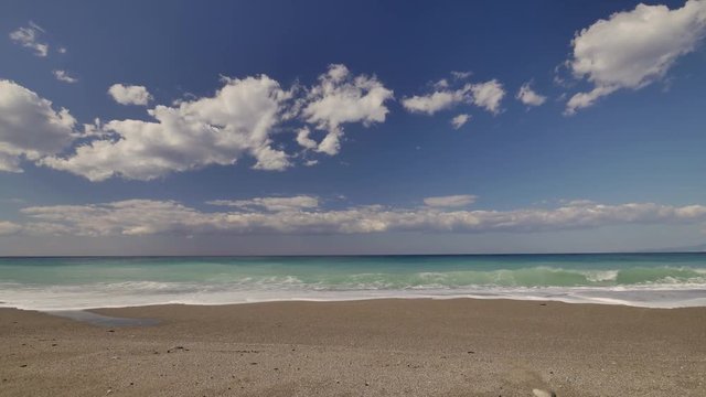 Beautiful waves on sandy beach on Sicili, Italy. Sunny day on the beach.
