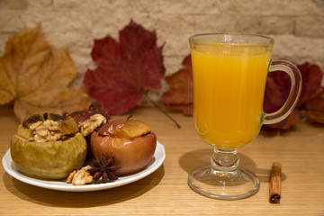 Tea with sea-buckthorn and spices. Baked apples, red and yellow, stuffed with raisins and nuts...