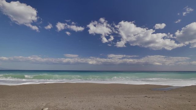 Beautiful waves on sandy beach on Sicili, Italy. Sunny day on the beach.