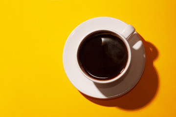 Cup of coffee on a bright background of fuchsia.