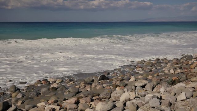 Beautiful waves on sandy beach on Sicili, Italy. Sunny day on the beach.