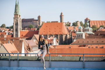 Young woman tourist enjoying beautiful aerial view on the old town of Nurnberg city, Germany