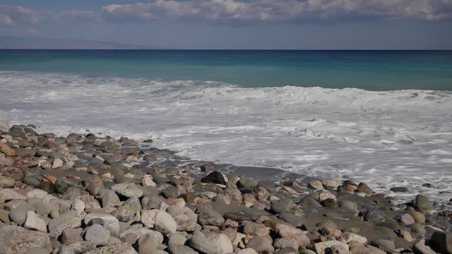 Beautiful waves on sandy beach on Sicili, Italy. Sunny day on the beach.