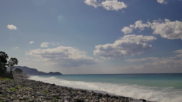 Beautiful waves on sandy beach on Sicili, Italy. Sunny day on the beach.