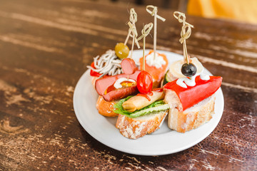 Spanish Tapas as traditional cuisine on vintage table in restaurant