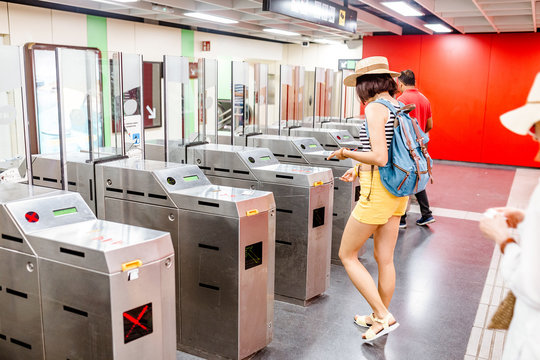 Woman enter in subway through turnstile, public railroad transport concept