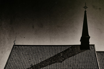 Print of a church tower with a shadow on the church roof, good for halloween with dust and scraches