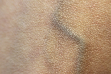 Macro skin of the human hand with one subcutaneous vein on the wrist.