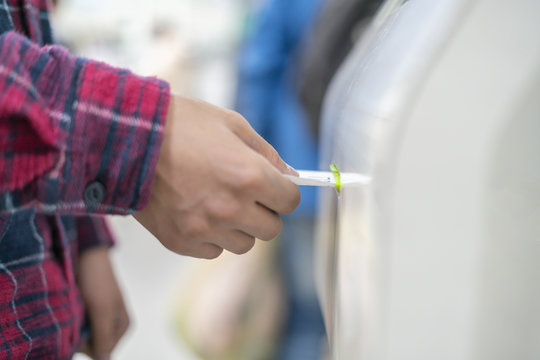 Close Up Customer Hand Pull A Ticket Number From Dispenser Machine To Wait In Queue In Post Office F