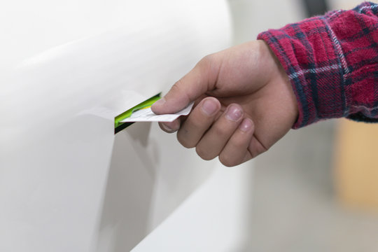 Close Up Customer Hand Pull A Ticket Number From Dispenser Machine To Wait In Queue In Post Office F