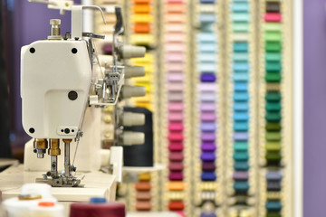 Sewing Machine and Blurred Colored Thread in the background